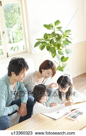 A family in the living room View Large Photo Image Stock Image - A family in the living room. Fotosearch