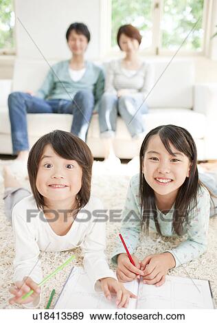 Stock Photo - A family in the living room. Fotosearch