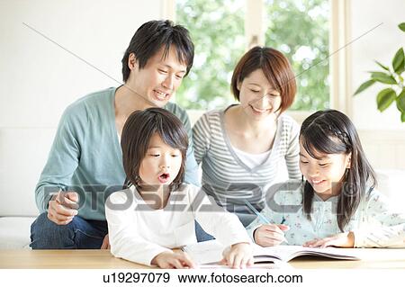 A family in the living room View Large Photo Image Stock Photo - A family in the living room. Fotosearch