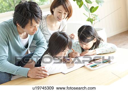 Stock Photo - A family in the living room. Fotosearch