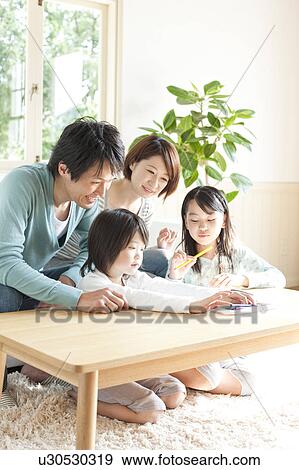 A family in the living room View Large Photo Image Stock Photo - A family in the living room. Fotosearch