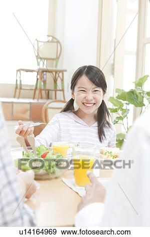 A girl having a meal View Large Photo Image Stock Photo - A girl having a meal. Fotosearch