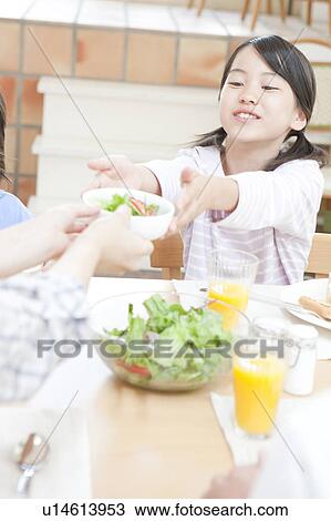 Stock Image - A girl receiving salad. Fotosearch