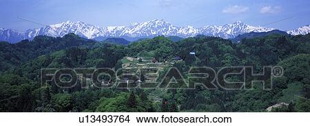 A small village and Tateyama mountain range in the background, Nagano Prefecture, Japan View Large Photo Image Picture - A small village and Tateyama mountain range in the background, Nagano Prefecture, Japan. Fotosearch