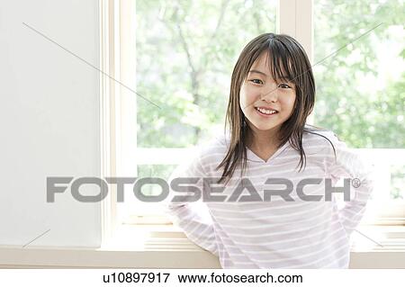 Stock Photo - A smiling girl. Fotosearch