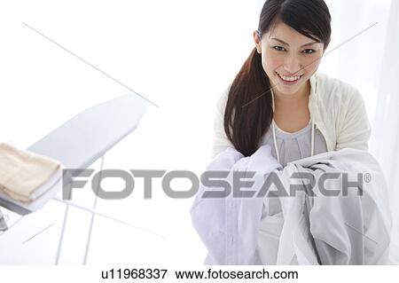 A woman carrying laundry View Large Photo Image Stock Photo - A woman carrying laundry. Fotosearch