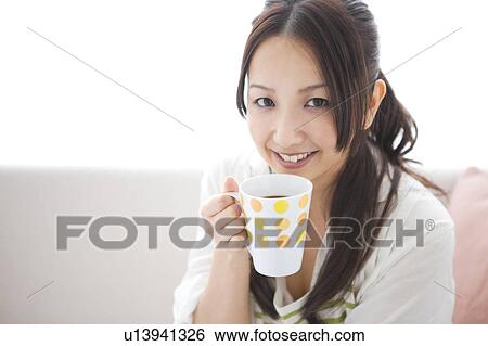Stock Photograph - A woman drinking coffee. Fotosearch
