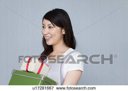 A woman holding an apple View Large Photo Image Stock Photo - A woman holding an apple. Fotosearch