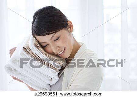 A woman holding towels View Large Photo Image Stock Image - A woman holding towels. Fotosearch