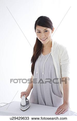 A woman ironing View Large Photo Image Stock Image - A woman ironing. Fotosearch