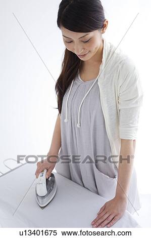 A woman ironing View Large Photo Image Stock Photography - A woman ironing. Fotosearch
