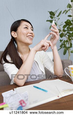 Picture - A woman keeping household accounts. Fotosearch