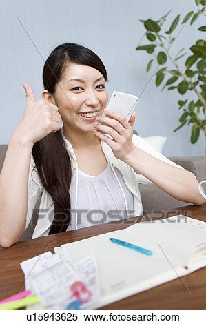 Stock Photography - A woman keeping household accounts. Fotosearch