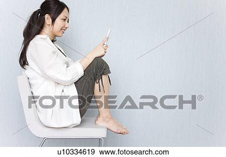 Stock Photo - A woman reading a text message. Fotosearch
