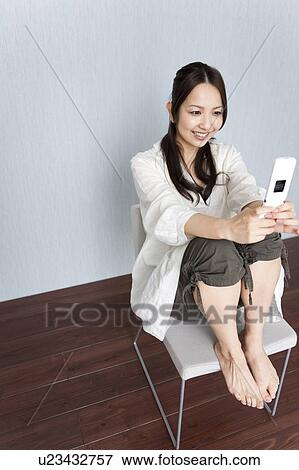 A woman reading a text message View Large Photo Image Stock Photo - A woman reading a text message. Fotosearch
