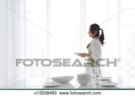 A woman setting a table View Large Photo Image Stock Photography - A woman setting a table. Fotosearch