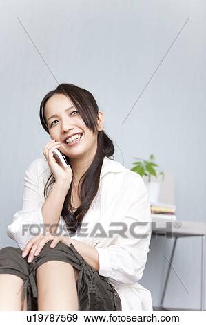 A woman talking on mobile phone View Large Photo Image Stock Photo - A woman talking on mobile phone. Fotosearch