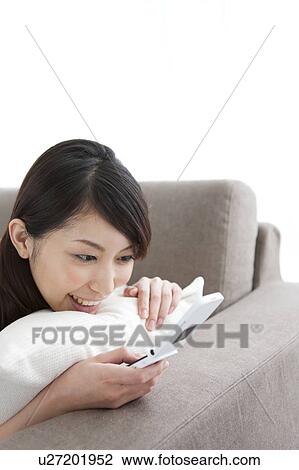 Stock Image - A woman texting. Fotosearch