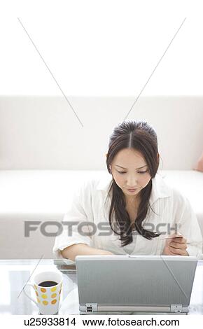Picture - A woman using PC. Fotosearch