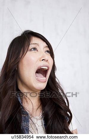 A young woman shouting View Large Photo Image Picture - A young woman shouting. Fotosearch
