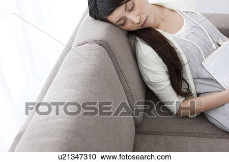 Stock Image - A young woman sleeping. Fotosearch
