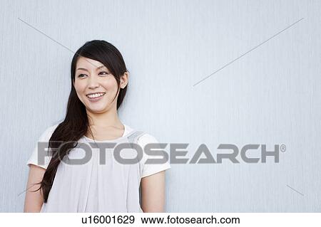 Stock Photo - A young woman smiling. Fotosearch