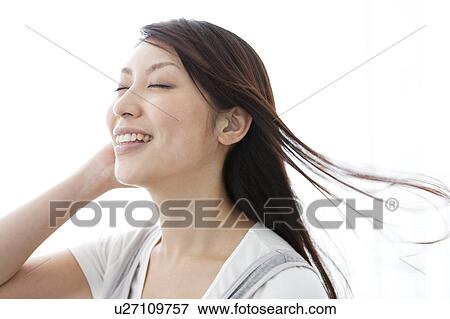 A young woman smiling View Large Photo Image Stock Photo - A young woman smiling. Fotosearch