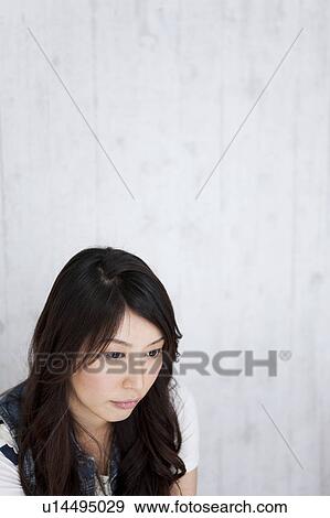 A young woman thinking View Large Photo Image Stock Photo - A young woman thinking. Fotosearch