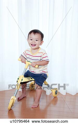 Baby Boy on Toy Tricycle View Large Photo Image Picture - Baby Boy on Toy Tricycle. Fotosearch