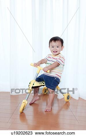 Baby Boy on Toy Tricycle View Large Photo Image Stock Image - Baby Boy on Toy Tricycle. Fotosearch