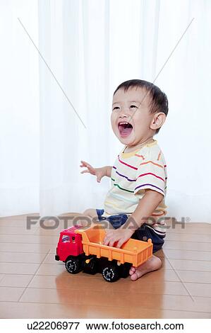 Baby Boy Playing With Toy Car View Large Photo Image Stock Photo - Baby Boy Playing With Toy Car. Fotosearch
