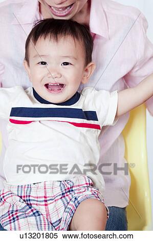 Baby Boy Sitting on Mother's Lap View Large Photo Image Stock Photography - Baby Boy Sitting on Mother's Lap. Fotosearch