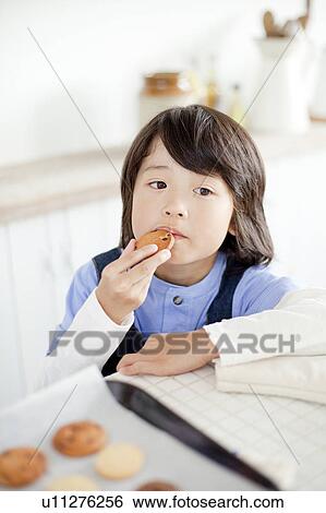 Boy eating a cookie, Hyogo Prefecture, Honshu, Japan View Large Photo Image Stock Photograph - Boy eating a cookie, Hyogo Prefecture, Honshu, Japan. Fotosearch