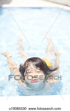 Stock Image - Boy in a swimming pool, Hyogo Prefecture, Honshu, Japan. Fotosearch