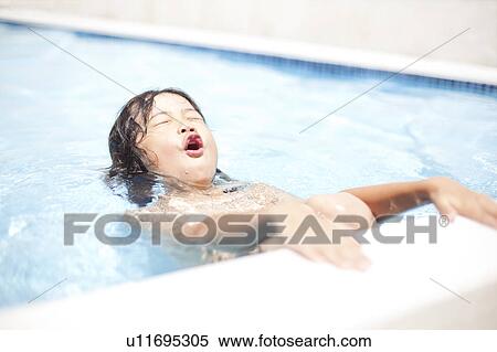 Stock Photography - Boy in a swimming pool, Hyogo Prefecture, Honshu, Japan. Fotosearch