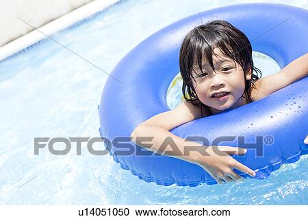 Stock Image - Boy with inflatable, Hyogo Prefecture, Honshu, Japan. Fotosearch