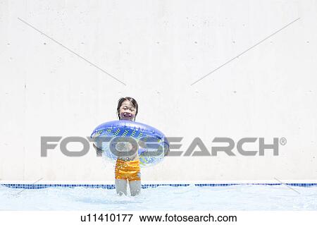 Stock Photo - Boy with inflatable, Hyogo Prefecture, Honshu, Japan. Fotosearch