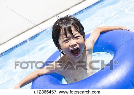 Stock Photo - Boy with inflatable, Hyogo Prefecture, Honshu, Japan. Fotosearch