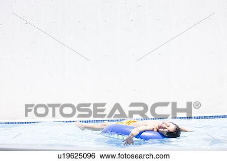 Stock Photograph - Boy with inflatable, Hyogo Prefecture, Honshu, Japan. Fotosearch