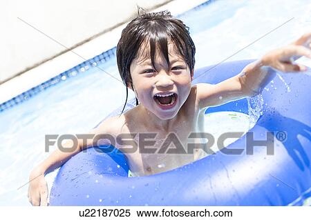 Stock Photography - Boy with inflatable, Hyogo Prefecture, Honshu, Japan. Fotosearch