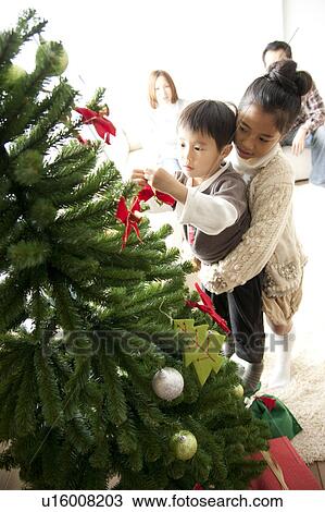 Brother and Sister Decorating Christmas Tree View Large Photo Image Stock Image - Brother and Sister Decorating Christmas Tree. Fotosearch