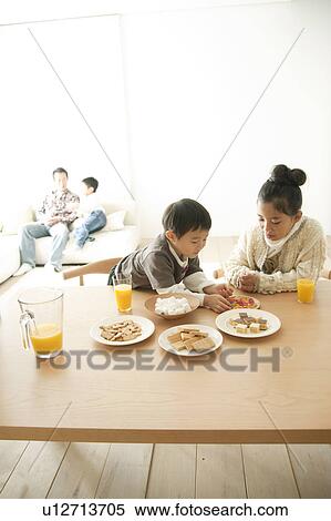 Brother and Sister Eating Sweets, Father and Another Brother in Background View Large Photo Image Stock Photography - Brother and Sister Eating Sweets, Father and Another Brother in Background. Fotosearch