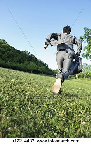 Stock Photo - Businesman Running, Low Angle View. Fotosearch