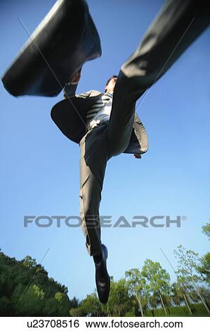 Stock Photograph - Businesman Running, Low Angle View. Fotosearch