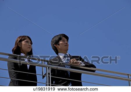 Stock Photo - Business people on rooftop, Shiga Prefecture, Honshu, Japan. Fotosearch
