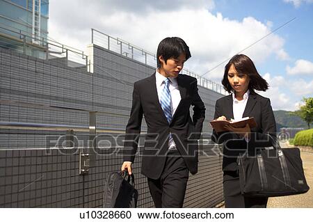 Business people walking outdoors, Shiga Prefecture, Honshu, Japan View Large Photo Image Stock Image - Business people walking outdoors, Shiga Prefecture, Honshu, Japan. Fotosearch