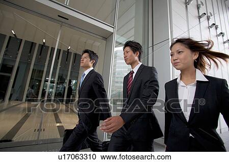 Stock Image - Business people walking outdoors. Fotosearch