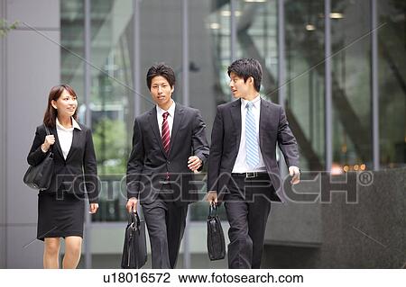 Stock Image - Business people walking outdoors. Fotosearch