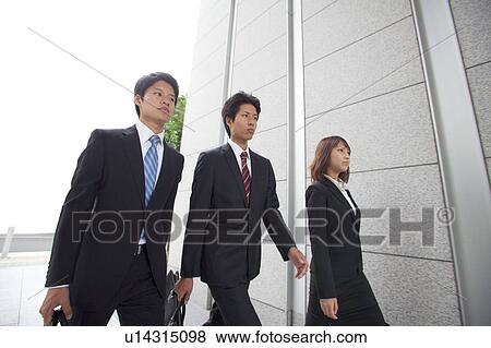 Stock Photo - Business people walking outdoors. Fotosearch