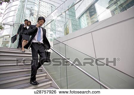Stock Photograph - Business people walking outdoors. Fotosearch
